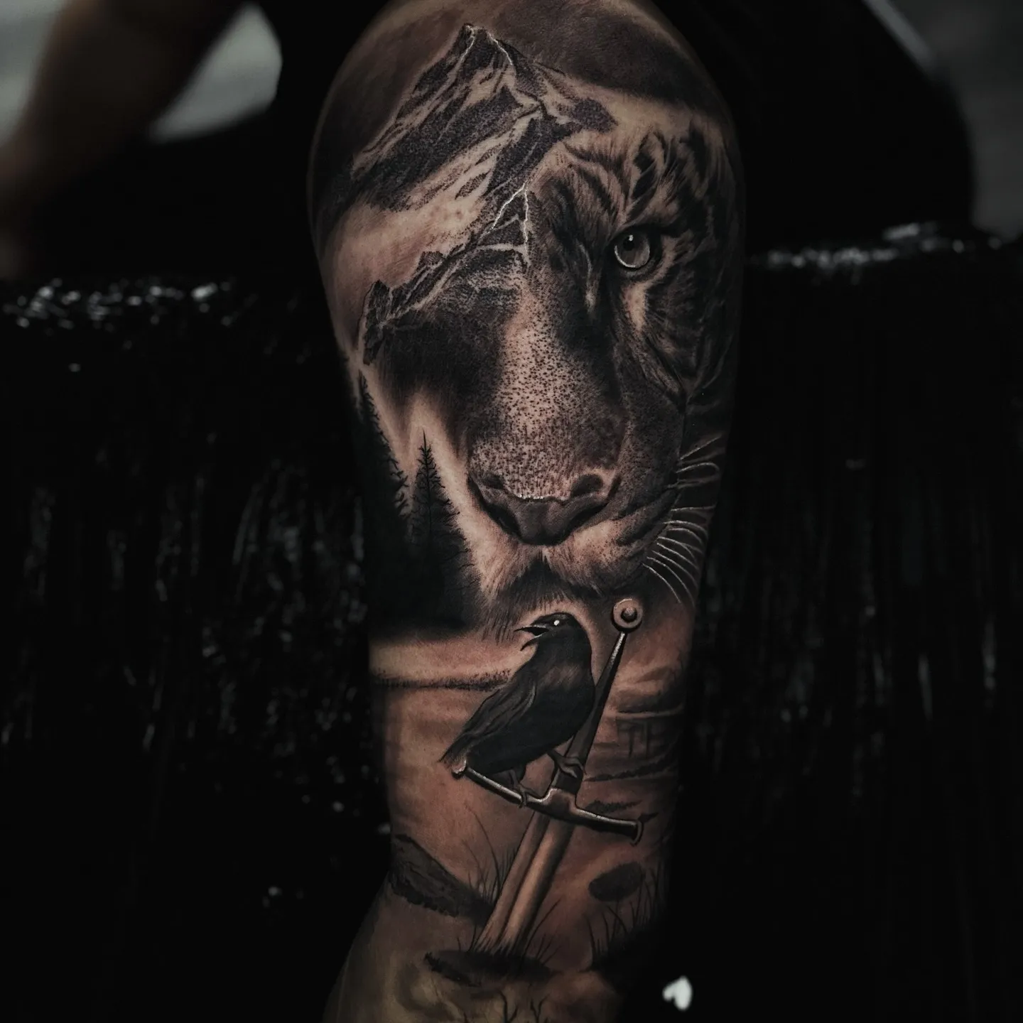 Realism tiger mountain and crow sleeve tattoo by Andrew Fernandez at Studio AZ Minneapolis