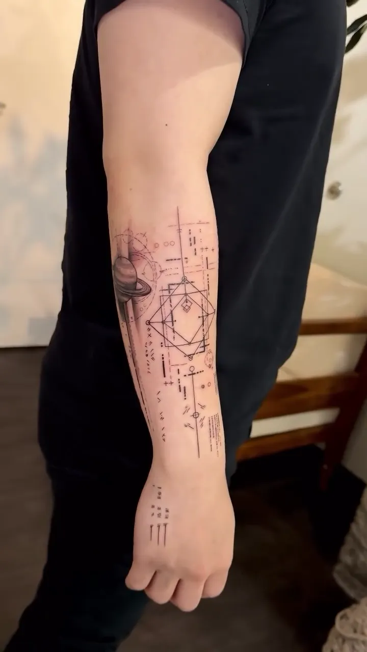 Fine line geometric planet tattoo on forearm by Joan Martinez at Studio AZ Tattoo Minneapolis
