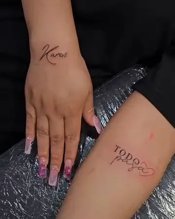 Fine line script names tattoo on hand by Joan Martinez at Studio AZ Tattoo Minneapolis